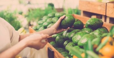 Woman buys avocados 