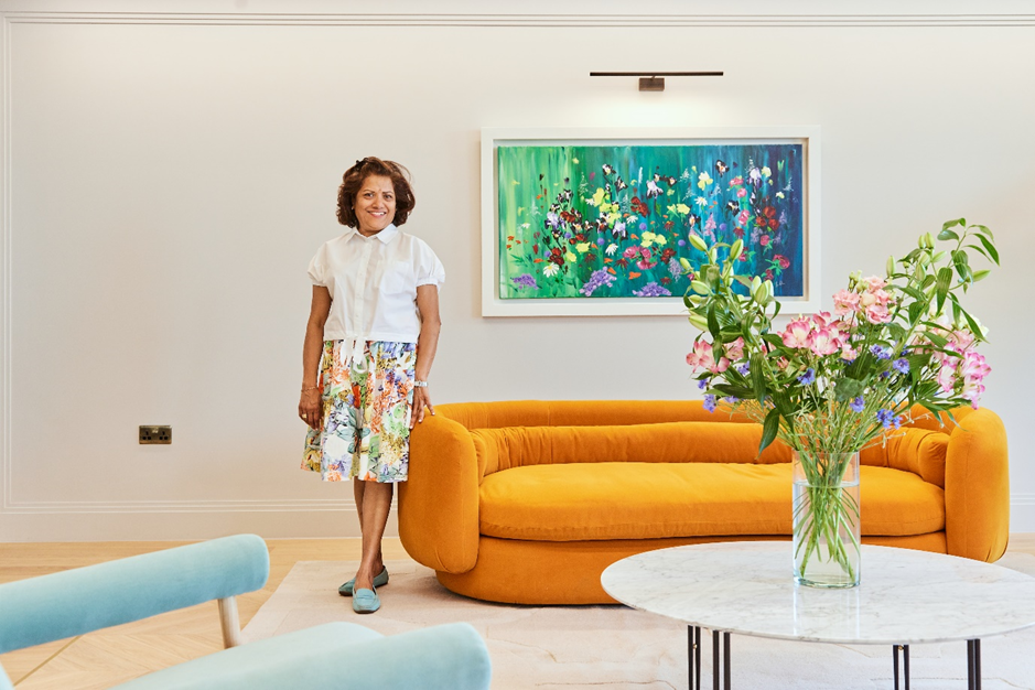 Brenda stands in reception by flowers